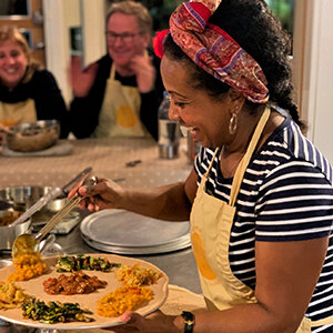 My name is Alganesh Michael. I live in South Burlington with my husband and two daughters. I’m originally from Eritrea, located in the Horn of Africa. I’m a former nurse turned homemaker for the last 16 years. Although not a chef by trade, I love to cook and entertain my family and friends. I have been working in collaboration with many local restaurants, in Chittenden &amp; Addison County, schools and communities for over 6 years. I host Ethiopian &amp; Eritrean cuisine and have popularized this ethnic cooking in the Lake Champlain region of Vermont. Among other things, I teach cooking classes, host parties for team building for educators, book club friends, birthday and retirement parties. Also, I cater private parties of any size. Post COVID I started offering weekly takeout dinner from a local store in South Burlington, The Mill Market &amp; Deli. I love to teach simple techniques to prepare ethnic food that is rich in flavor. Ethiopian &amp; Eritrean cooking relies on a diverse range of herbs and roots to develop characteristics quintessential to the cuisine. I pride myself on cooking &amp; serving food in a traditional way with authentic spices and serve on a large, family-style platter atop of Injera. Injera is unique staple food to both countries and also serves as an edible utensil. It’s best known for spongy sourdough flatbread; one can’t really have an authentic feast without it.
